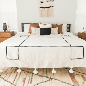 Handwoven Moroccan Pom Pom Blanket • wool throw blanket with black pattern • home decor and cozy snuggling • customizable dimensions.