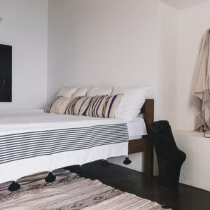 Hand-Woven Moroccan Pom Pom Blanket in White with Black Pom Poms