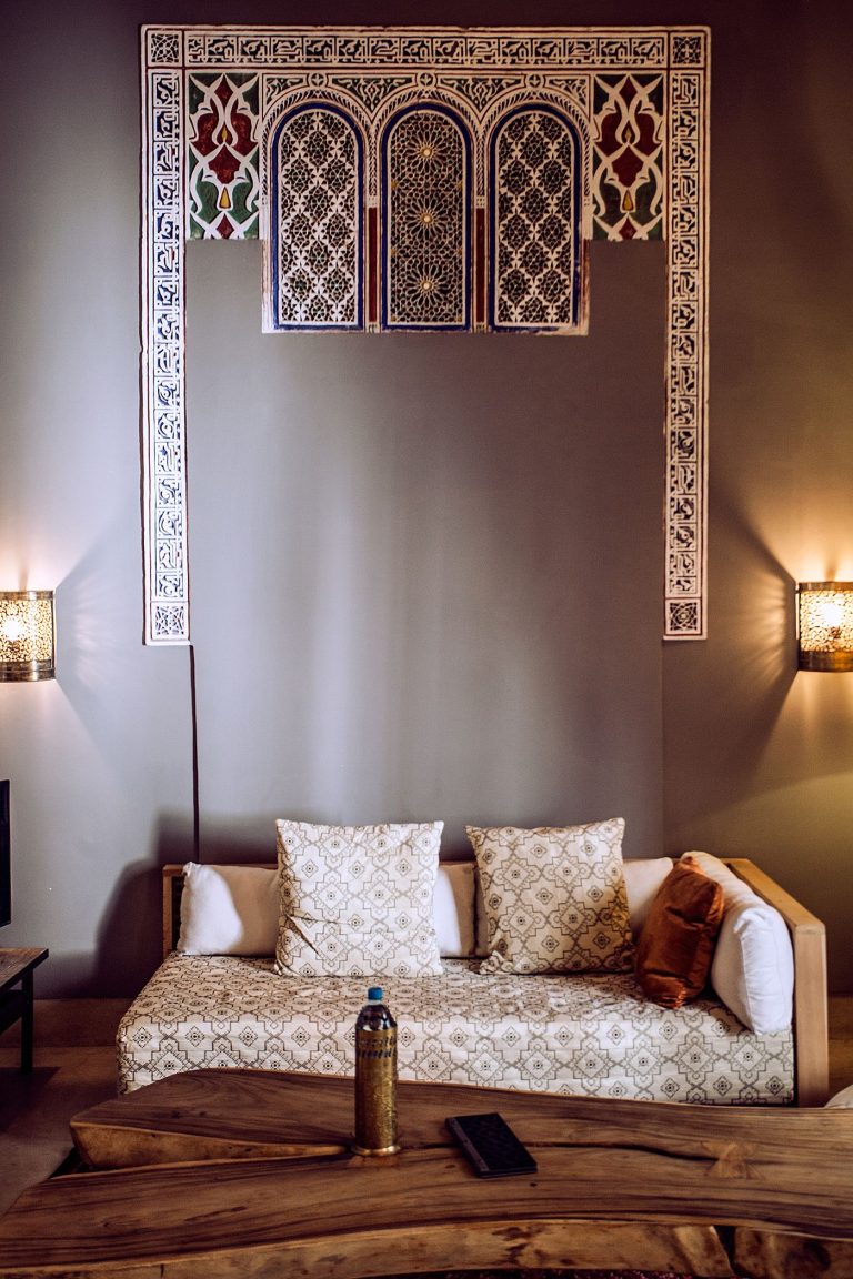 Banquette between carved sconces