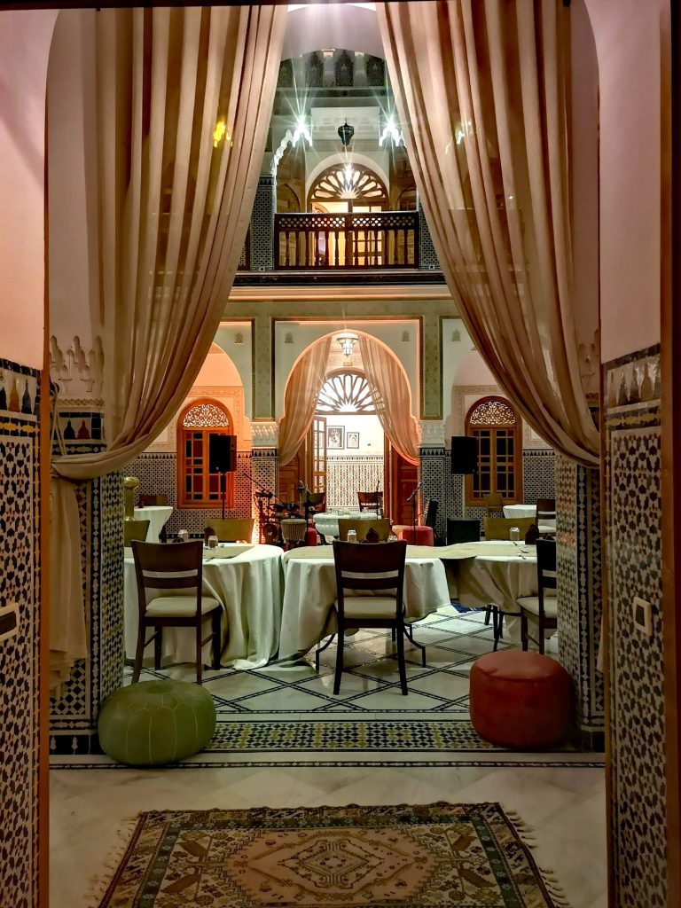 Green tables by the arch windows